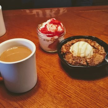 Outback Steakhouse - Toffee cookie skillet with ice cream, strawberry parfait, and a hot coffee. - Steakhouses Near Me - Raleigh, North Carolina Outback Steakhouse - Toffee cookie skillet with ice cream, strawberry parfait, and a hot coffee. - Steakhouses Near Me - Raleigh, North Carolina
