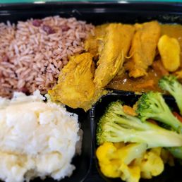 Curry chicken., rice, mashed potatoes, and veggies
