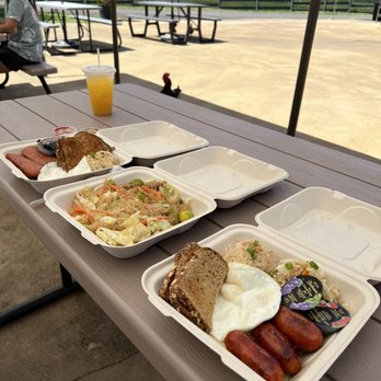 Manna on Wheels - a picnic table full of food - Food Trucks Near Me - Lihue, Hawaii