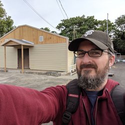 Joy Christian Ministries - Selfie with the Pastor and the church building.