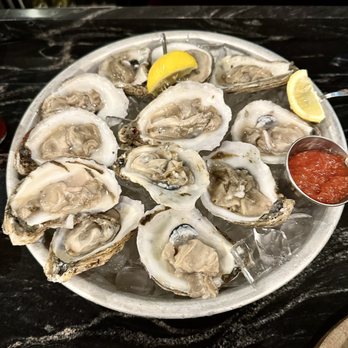 Towson Tavern - a plate of oysters with a side of sauce - American Near Me - Towson, Maryland Towson Tavern - a plate of oysters with a side of sauce - American Near Me - Towson, Maryland
