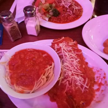 Capone's Dinner & Show - Chicken parm foreground. - American Near Me - Orlando, Florida Capone's Dinner & Show - Chicken parm foreground. - American Near Me - Orlando, Florida