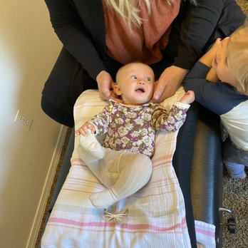Natural Life Chiropractic - Gentle chiropractic exam and adjustment of a sweet little baby girl. - Chiropractors Near Me - Eagle, Idaho Natural Life Chiropractic - Gentle chiropractic exam and adjustment of a sweet little baby girl. - Chiropractors Near Me - Eagle, Idaho