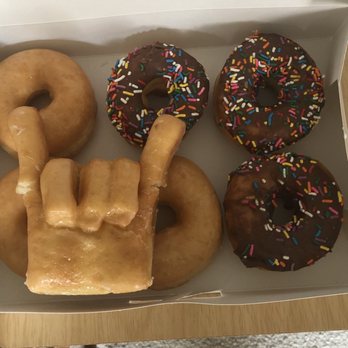 Best Donuts - I accidentally tore the pink and thumb from their signature 'rock on' doughnut while trying to take a picture :(. - Donuts Near Me - Pearland, Texas Best Donuts - I accidentally tore the pink and thumb from their signature 'rock on' doughnut while trying to take a picture :(. - Donuts Near Me - Pearland, Texas