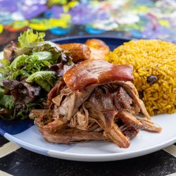 Pernil served w/ arroz con gandules (Roast Port Shoulder served with Yellow rice and pigeon peas).