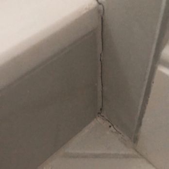 Full Service USA - Grout cracking on step outside shower.  After only 2 weeks - General Contractors Near Me - Hallandale Beach, Florida