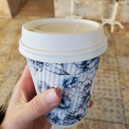 a hand holding a cup of coffee