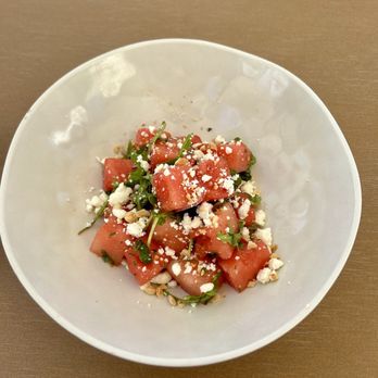 Bel-Aire Backyard - Summer Watermelon Salad - Feta, cucumber, mint, sliced red onion, Marcona almonds, lemon, mint vinaigrette. - New American Near Me - Las Vegas, Nevada