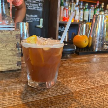 The West - a glass of iced tea with a straw and orange wedge - Coffee & Tea Near Me - Brooklyn, New York