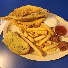 Whole fried catfish, fries, garlic bread, hush puppies Whole fried catfish, fries, garlic bread, hush puppies