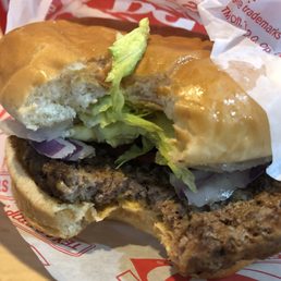 a hamburger with lettuce and onions a hamburger with lettuce and onions