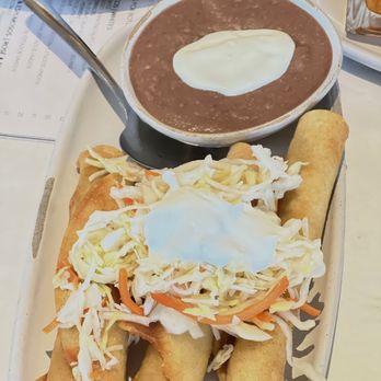Madrono Restaurant - Chicken Taquitos with slaw and sour cream Taquitos de pollo con repollo y crema - Latin American Near Me - Miami, Florida Madrono Restaurant - Chicken Taquitos with slaw and sour cream Taquitos de pollo con repollo y crema - Latin American Near Me - Miami, Florida