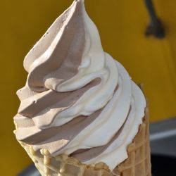 Kippy's Kustard - Close-up of the Vanilla Chocolate Twist Frozen Custard inside a large Waffle Cone.
