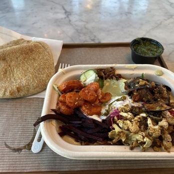 Brassica - Hummus bowl with veggies (before I started eating it). Side of Z'hug (Hot Sauce) (made with jalapeños and cilantro) - Mediterranean Near Me - Shaker Heights, Ohio