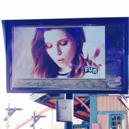 Music videos playing to entertain people in line
