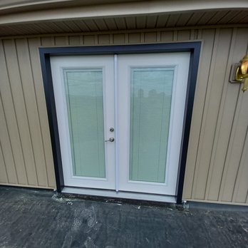 Rosie Construction - French doors on the second floor balconies with built in blinds. - General Contractors Near Me