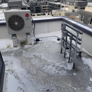 SQI Inc Roofing and Restoration - An example of "ponding" around penetration's that has frozen. Potential for damage to the penetration seal from ice expansion. - Roofing Near Me - Mukilteo, Washington SQI Inc Roofing and Restoration - An example of "ponding" around penetration's that has frozen. Potential for damage to the penetration seal from ice expansion. - Roofing Near Me - Mukilteo, Washington