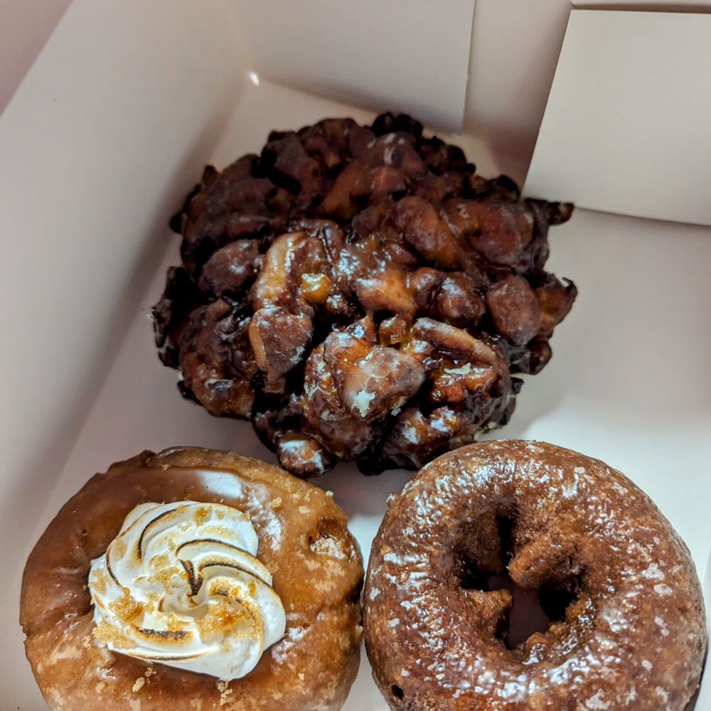 Pinkbox Doughnuts - Vegan blueberry fritter (top), Sweetie Pie (lower left), Dark & Simple (lower right) - Donuts Near Me - Laughlin, Nevada Pinkbox Doughnuts - Vegan blueberry fritter (top), Sweetie Pie (lower left), Dark & Simple (lower right) - Donuts Near Me - Laughlin, Nevada