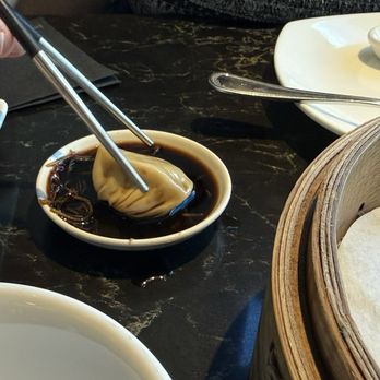 Din Tai Fung - Dipping the bao. Very tasty - Dim Sum Near Me - Anaheim, California
