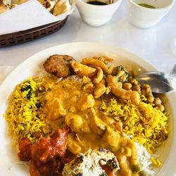 Amber Indian Restaurant - A color melange of flavorful curries atop several rices. Pakoras and chutney.