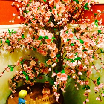 Thai Jasmine - a small figurine of a man sitting under a flowering tree - Vietnamese Near Me - Leominster, Massachusetts Thai Jasmine - a small figurine of a man sitting under a flowering tree - Vietnamese Near Me - Leominster, Massachusetts