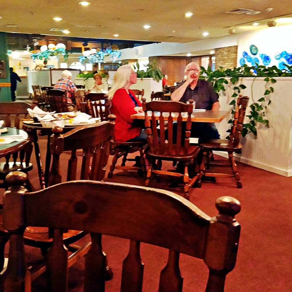 people sitting at tables in a restaurant people sitting at tables in a restaurant