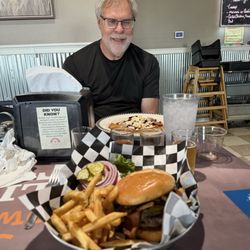 Buffalo Joe's Roadhouse - John happy at the sight of his delectable meal. My Val'Hala Burger looks awesome. The beer flight was good too!