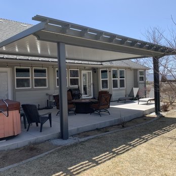 Shade Concepts - a covered patio with a hot tub - Patio Coverings Near Me