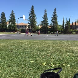 Watching some friends play basketball after the kick ball game.