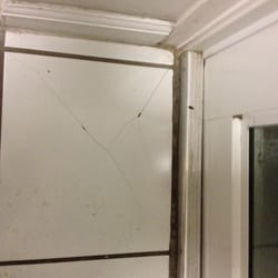 Compass Realty - Broken floor tiles in the kitchen.