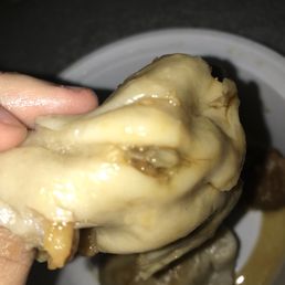 a hand holding a piece of food