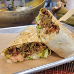 Divine Leaf Vegan - The Great Beyond Wrap is stuffed with smoked BBQ Beyond meat, Cilantro Aioli, lettuce, tomato, onion.