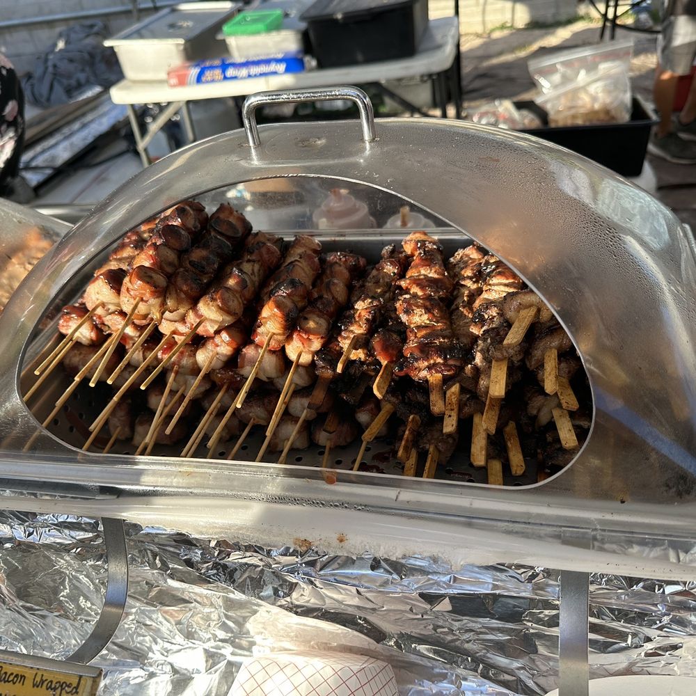 Oh’s Kitchen - a grill with skewers on it - Food Stands Near Me - Honolulu, Hawaii