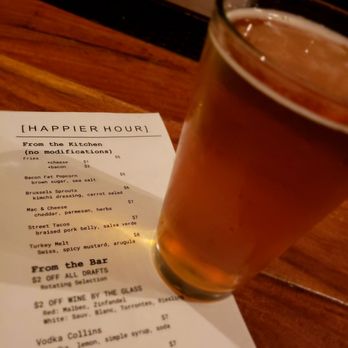 The Salted Pig - that it is "Happier" hour. Checking the menu aided by Bottle Logic 714 California Blonde Ale on draft - Gastropubs Near Me - Riverside, California