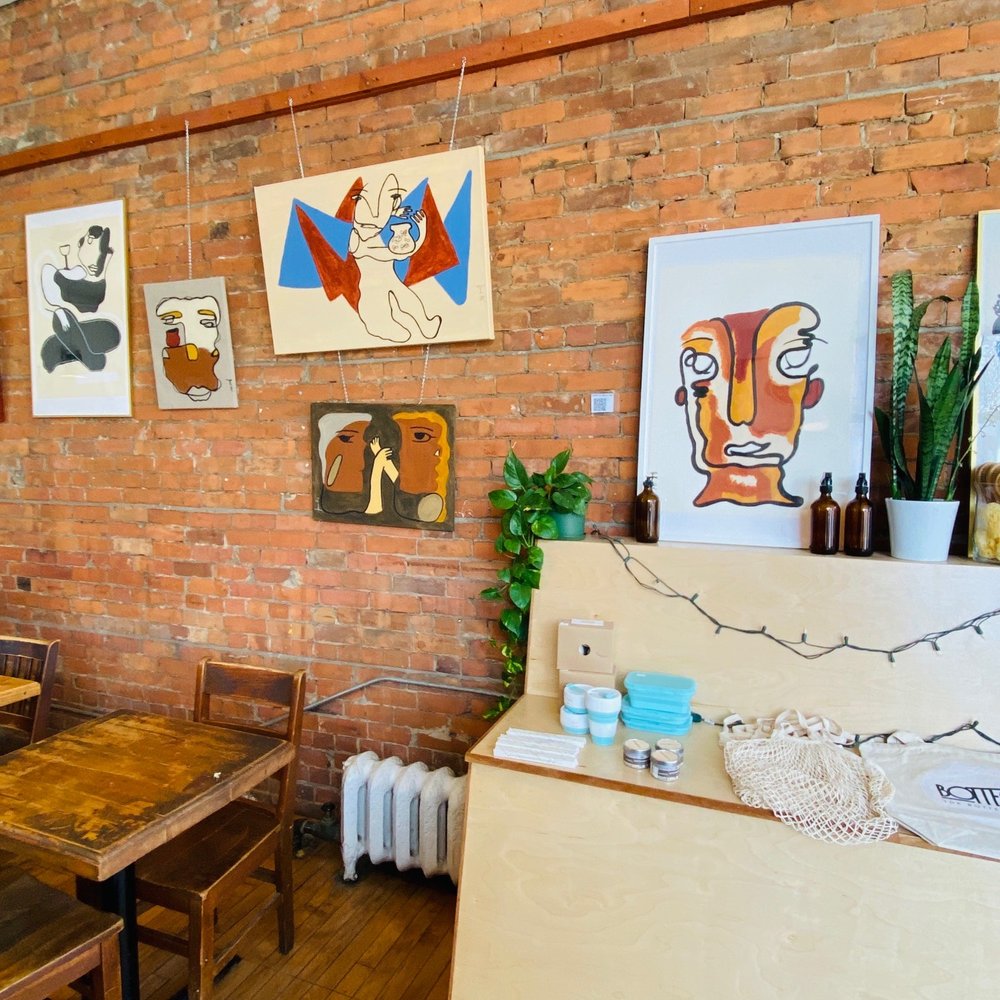 Capital Espresso - a brick wall with art on it - Coffee & Tea Near Me - Toronto, Ontario