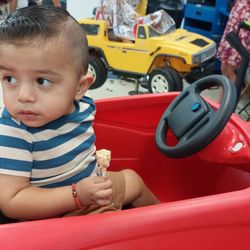 Cool Cuts 4 Kids - Riding in the hair cut cars with a lollipop provided by stylist