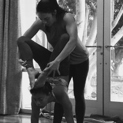 The Yoga Shala - Krista adjusting a student in a more challenging yoga posture