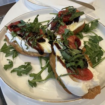 Tessora’s Wine Bar - Burrata Crostini $12 Creamy burrata on crispy crostini, topped with cherry tomatoes, fresh basil, and a balsamic glaze. - Wine Bars Near Me - Campbell, California Tessora’s Wine Bar - Burrata Crostini $12 Creamy burrata on crispy crostini, topped with cherry tomatoes, fresh basil, and a balsamic glaze. - Wine Bars Near Me - Campbell, California
