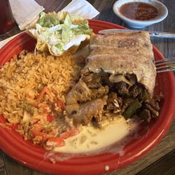 Mi Casita - Machaca chimichanga with rice, flag salad, and cheese sauce.