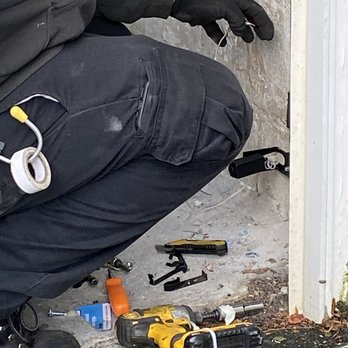 Precision Door Service - Leo Rosado, Engineer installing the new sensor - Garage Door Services Near Me - Mamaroneck, New York