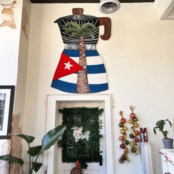 Cafe Con Leche Coffee & Bakery - a statue of a man with a cuban flag - Sandwiches Near Me - Woodbury, Georgia