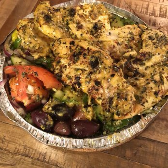 Sparta - a plate of food on a wooden table - Greek Near Me - Montreal, Quebec Sparta - a plate of food on a wooden table - Greek Near Me - Montreal, Quebec