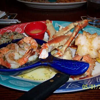 Red Lobster - Oven baked lobster tail, steamed crab legs and garlic shrimp served with over buttered wild rice pilaf - Seafood Near Me - Tacoma, Washington Red Lobster - Oven baked lobster tail, steamed crab legs and garlic shrimp served with over buttered wild rice pilaf - Seafood Near Me - Tacoma, Washington
