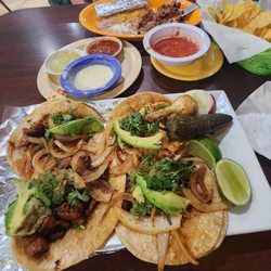 La Hacienda - Carnitas, Chorizo, Al Pastor, & Pollo Asada Street Tacos. Pechuga con Chorizo on back plate. Chips,  Salsa, queso, & hot sauces