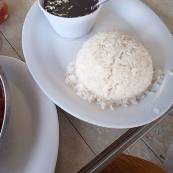 Rincon Criollo Restaurant - a plate of rice and a bowl of sauce - Cuban Near Me - Miami, Florida Rincon Criollo Restaurant - a plate of rice and a bowl of sauce - Cuban Near Me - Miami, Florida