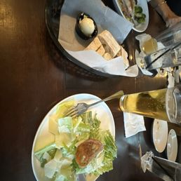 Caesar Salad, fresh made bread, and a bud light Caesar Salad, fresh made bread, and a bud light