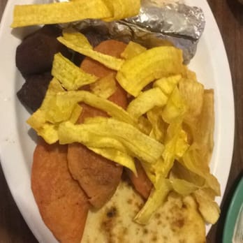 El Salvador Restaurant - One tamale, plantain chips, fried yucca, three pieces of chicharones, meat and potato pastelitos, two pupusas, and cabbage. - Salvadoran Near Me - Mesa, Arizona