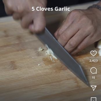 Ohana Food Trailer - a person chopping garlic - Filipino Near Me Ohana Food Trailer - a person chopping garlic - Filipino Near Me