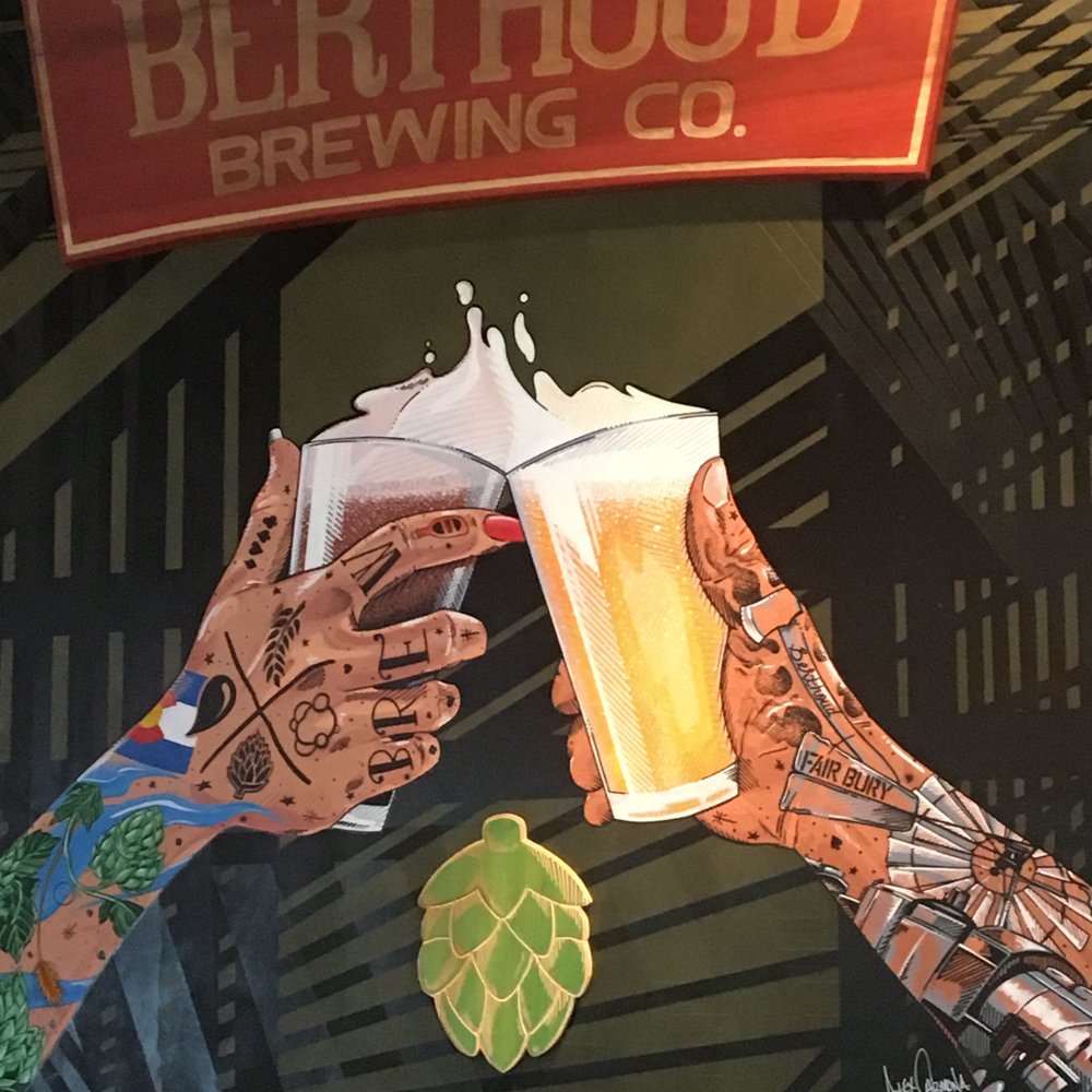 two hands holding beer glasses