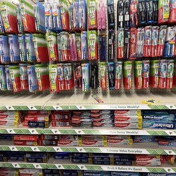Dollar Tree - The image shows a store shelf stocked with various toothbrushes and toothpaste brands, including Colgate and UltraBrite. - Discount Store Near Me - Colma, California